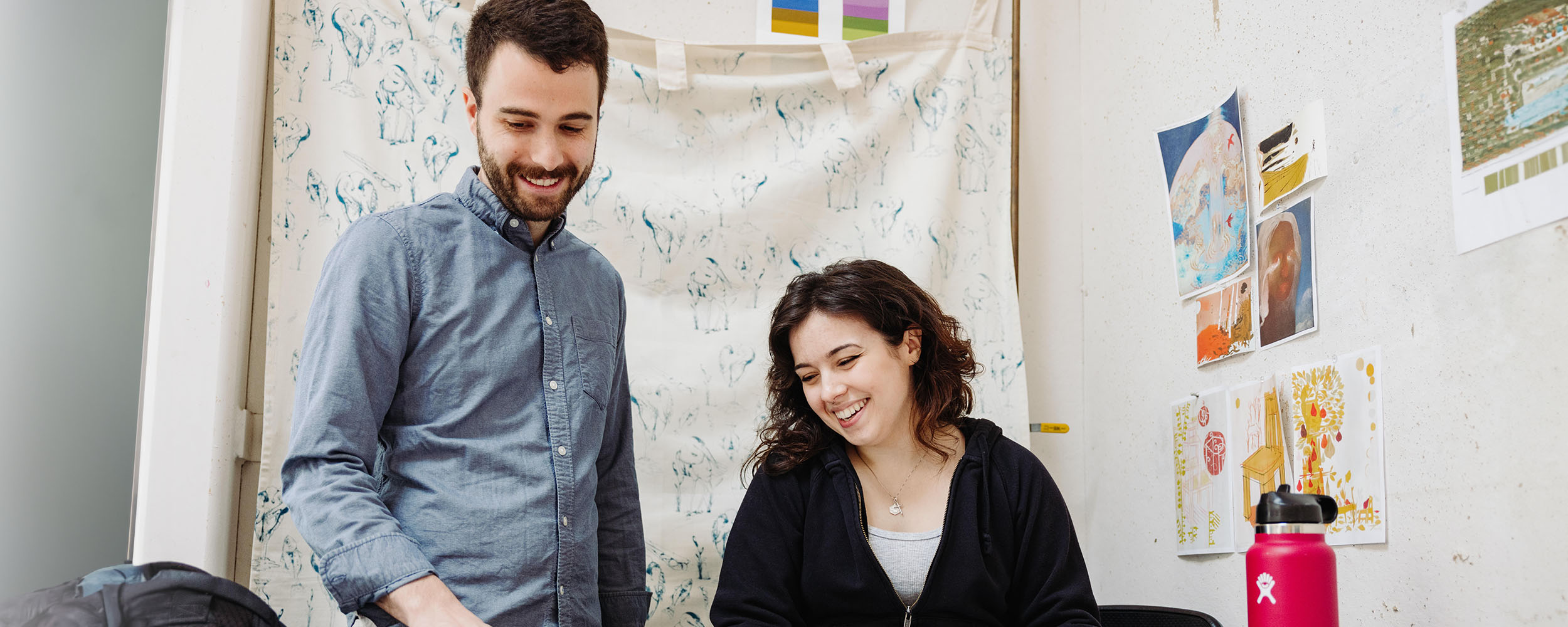 art professor and student working in the studio