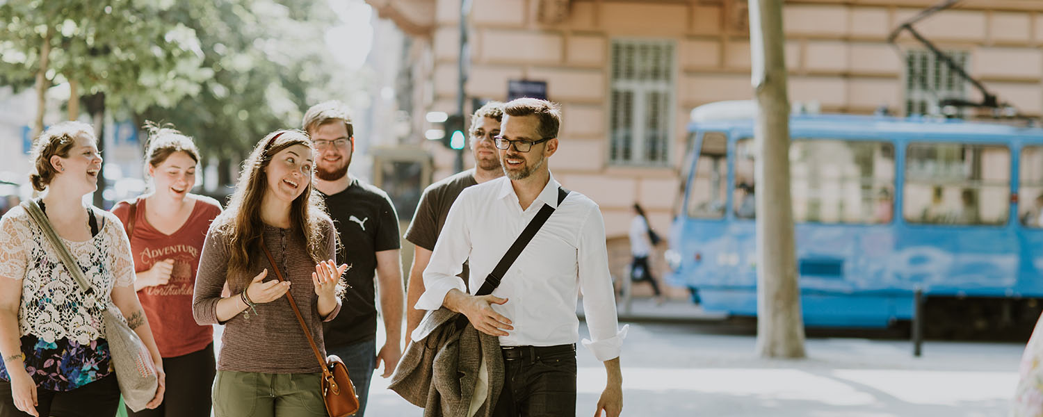 Students and professor walking in city