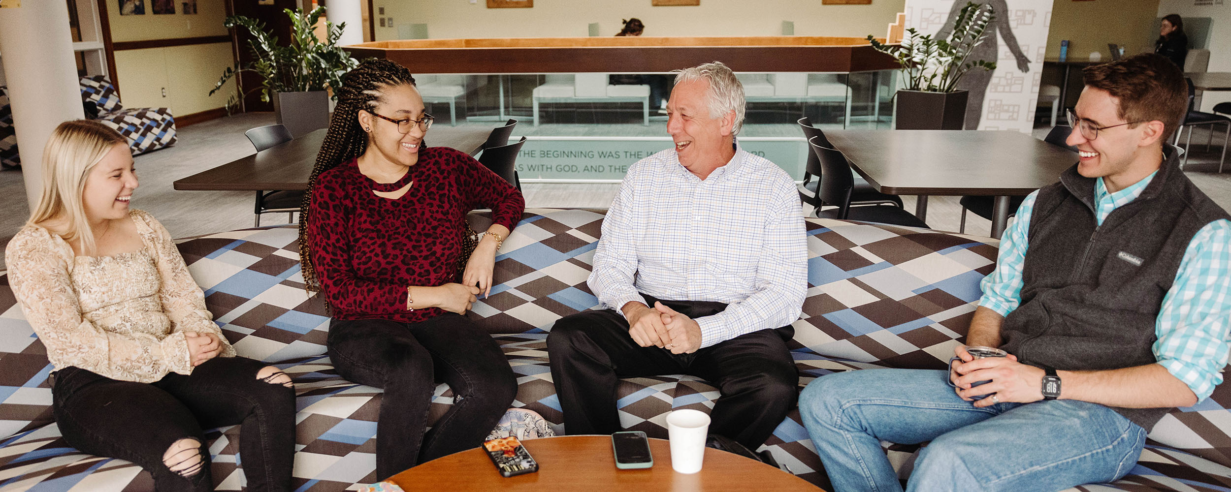 business students in conversation with professor