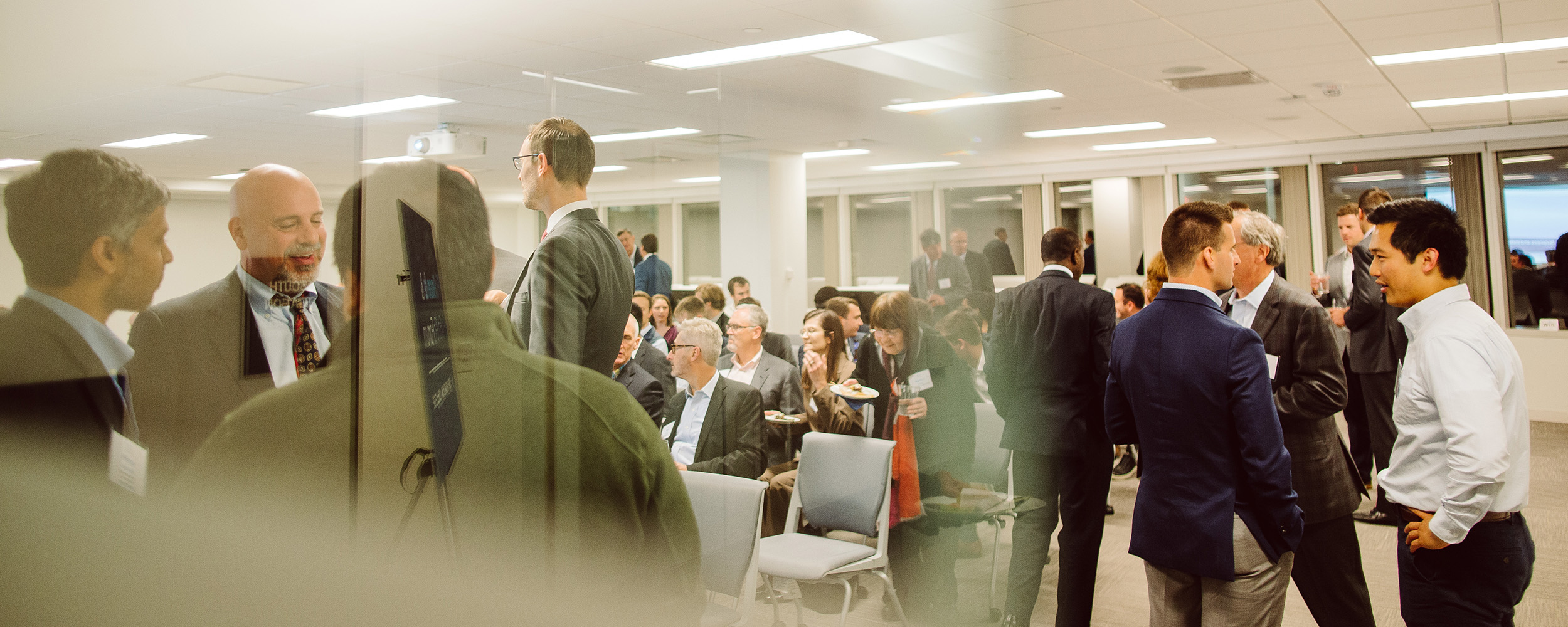 overlayed images of business people talking and waiting for a presentation to begin