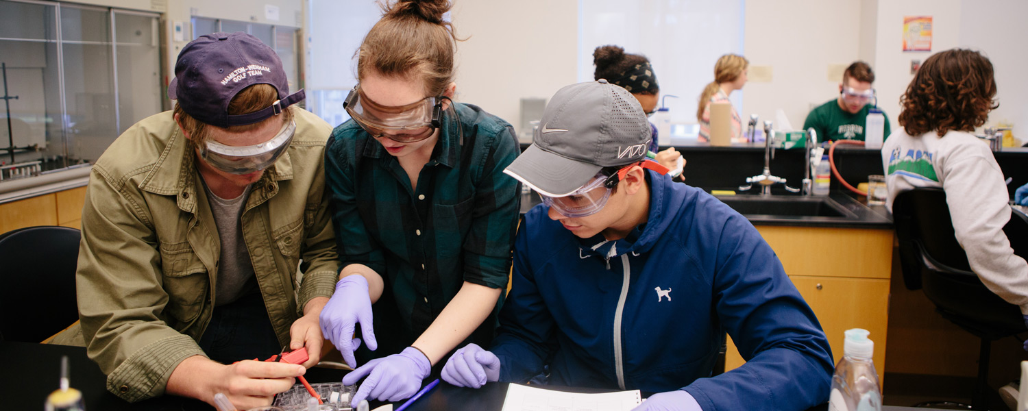 Three chemistry major students at Gordon College working together in a lab