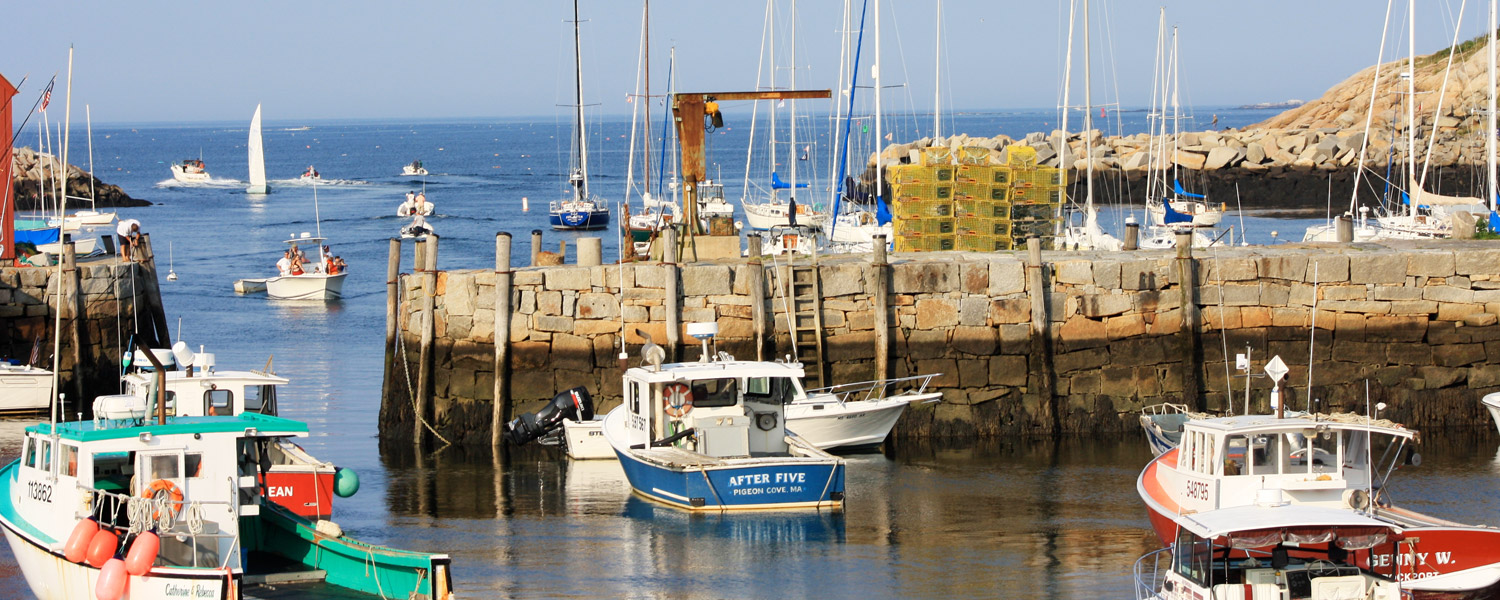 Multiple boats docked on the water in Massachusetts.