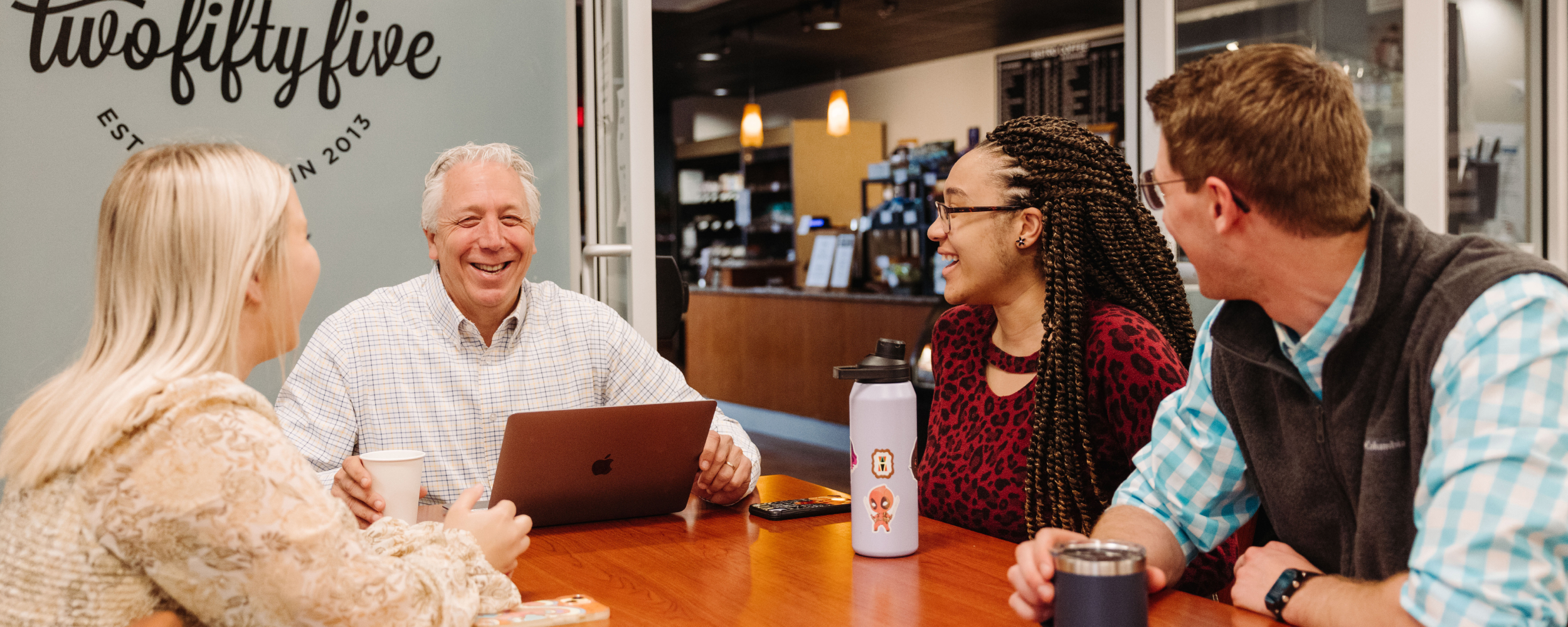 a faculty member at a top Christian college talking to a group of students on campus 