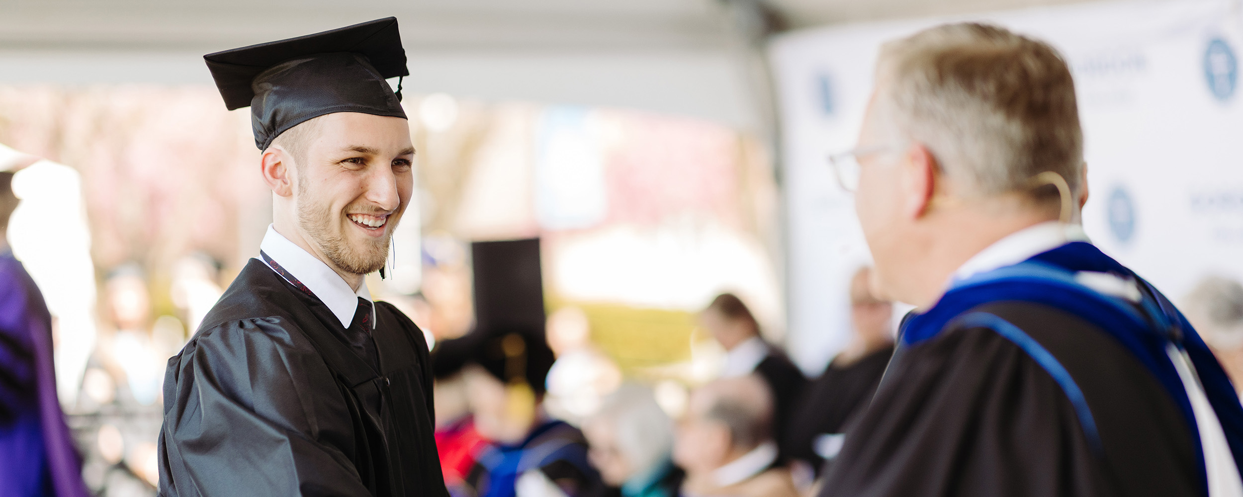 student smiling on stage