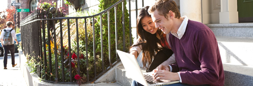 Students using laptop together