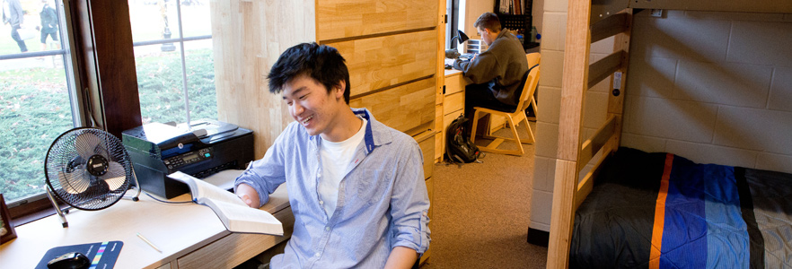 Two students in their dorm doing homework at gordon college