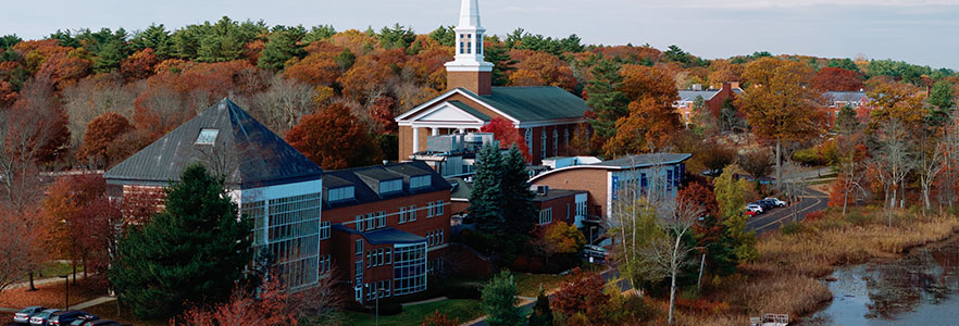 Aerial view of campus and pond in fall