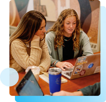 photo of a students looking at their laptop.