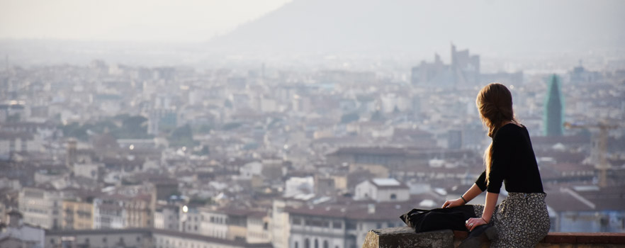 student looking out over city